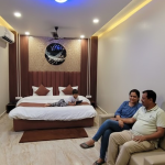 Best room in Orai with comfortable bed and family seating area