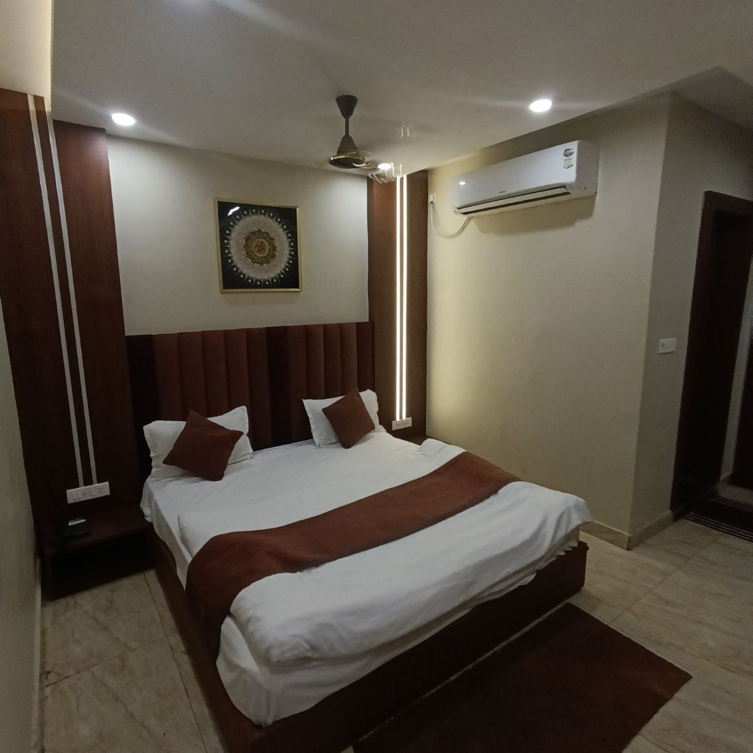 AC hotel room in Orai with comfortable bed and modern amenities