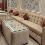 Spacious living area with sofa and modern interiors in a hotel room in Orai