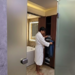 Hotel room wardrobe and attached modern bathroom in Orai