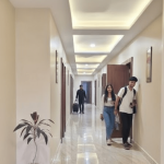 Clean hotel corridor with rooms in Orai Uttar Pradesh