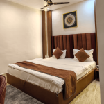 Comfortable double bed in deluxe hotel room in Orai Uttar Pradesh